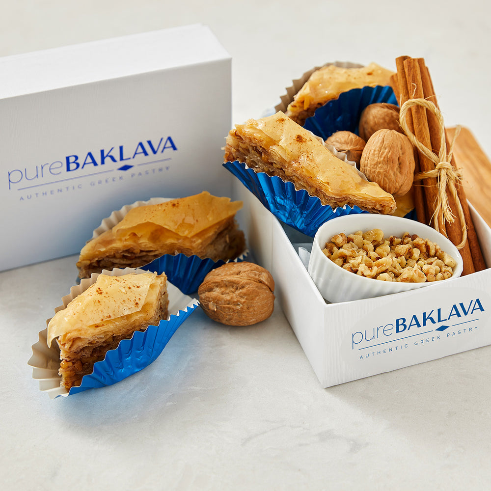 
                  
                    pureBaklava - authentic greek pastry shown in box with walnuts and cinnamon sticks
                  
                